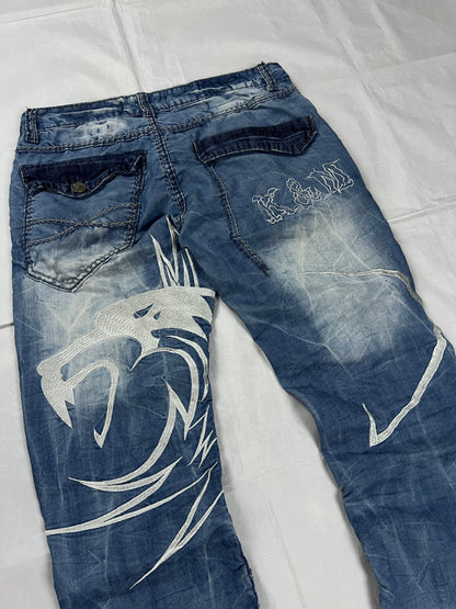 KJM blue denim jeans with white embroidered lion and logo, patchwork stitch detailing.