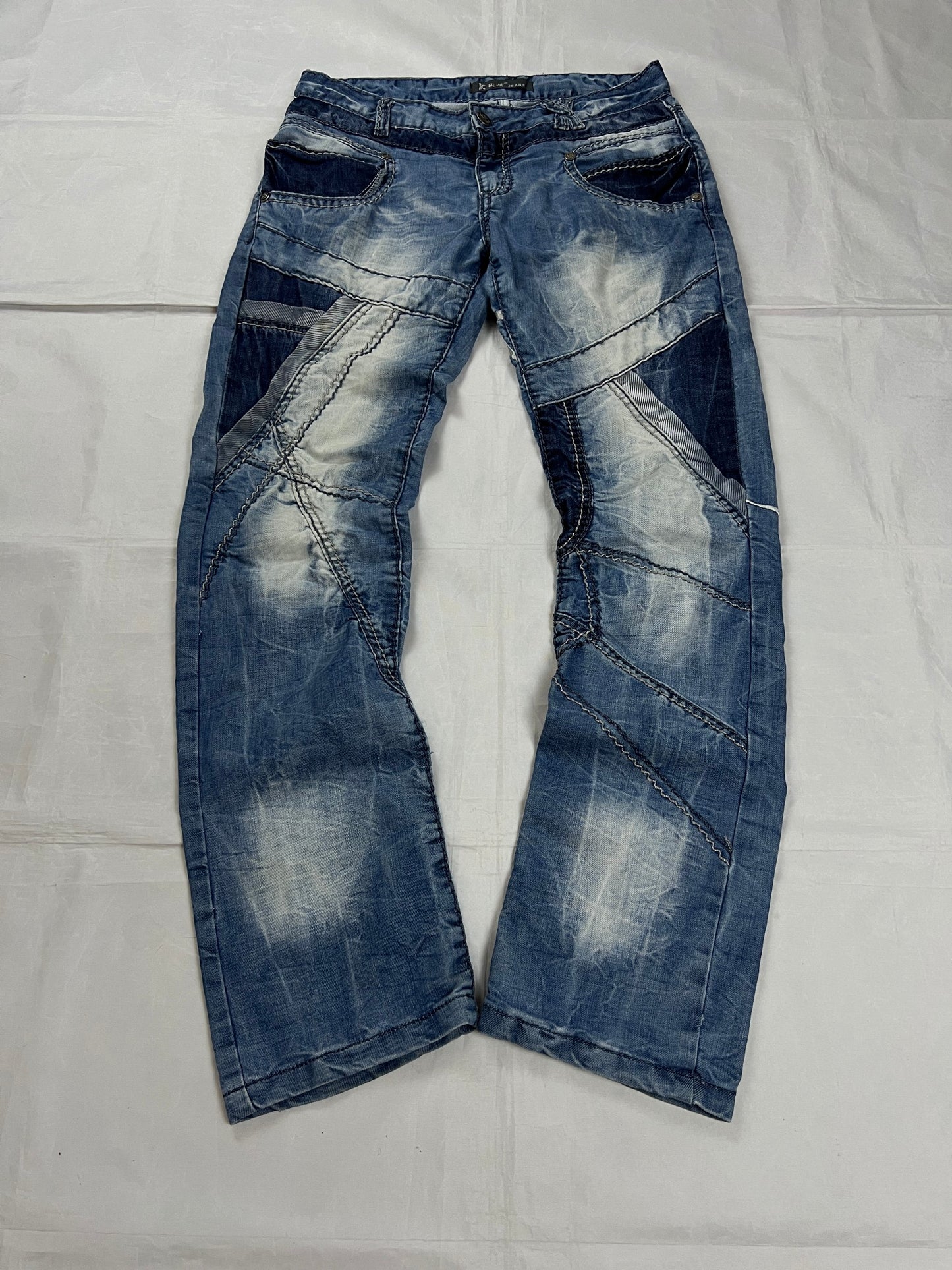 KJM blue denim jeans with white embroidered lion and logo, patchwork stitch detailing.