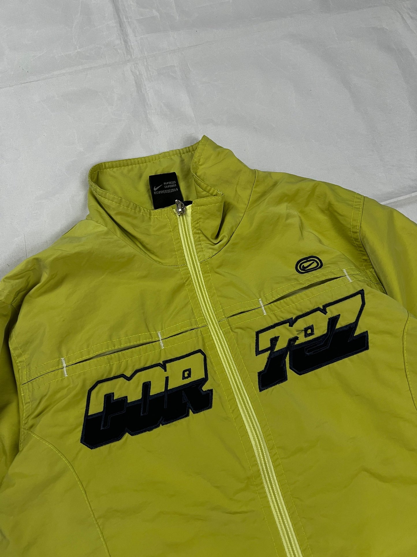 Nike yellow track jacket lightweight nylon with bold embroidered logos and sleeve zipper vent.