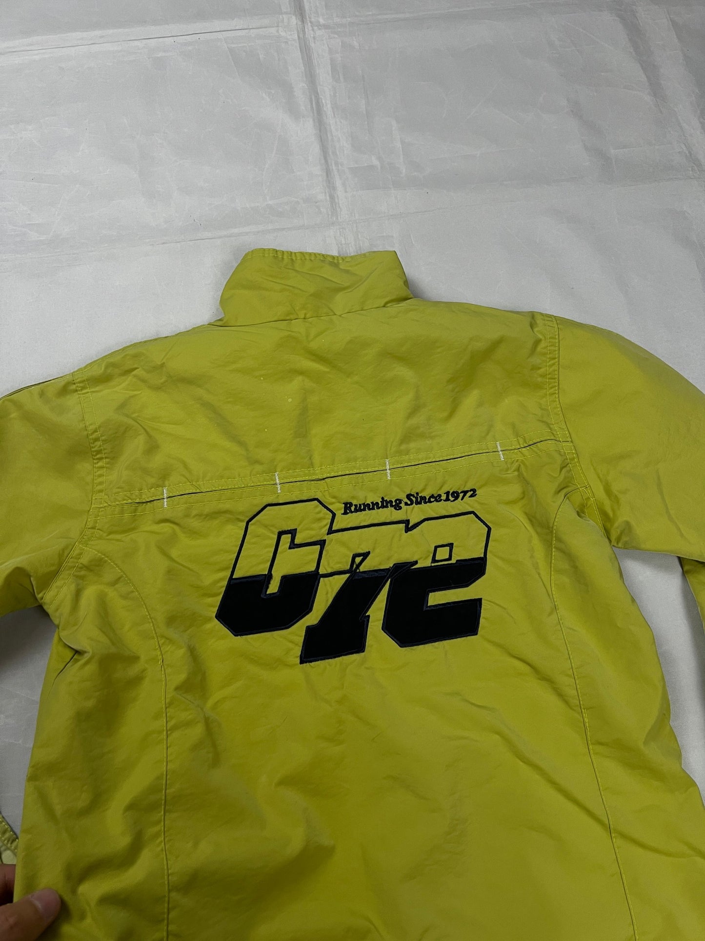 Nike yellow track jacket lightweight nylon with bold embroidered logos and sleeve zipper vent.