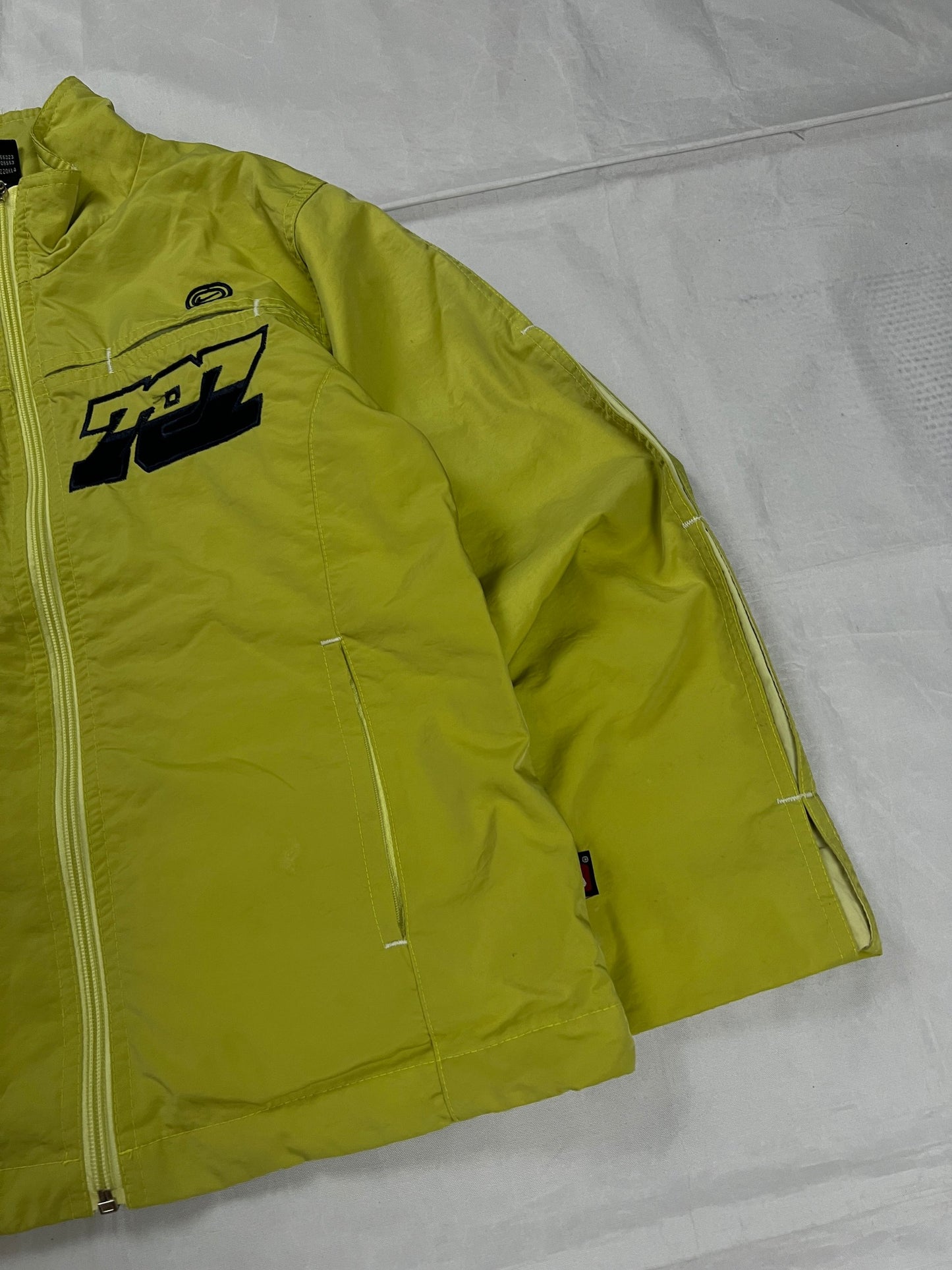 Nike yellow track jacket lightweight nylon with bold embroidered logos and sleeve zipper vent.