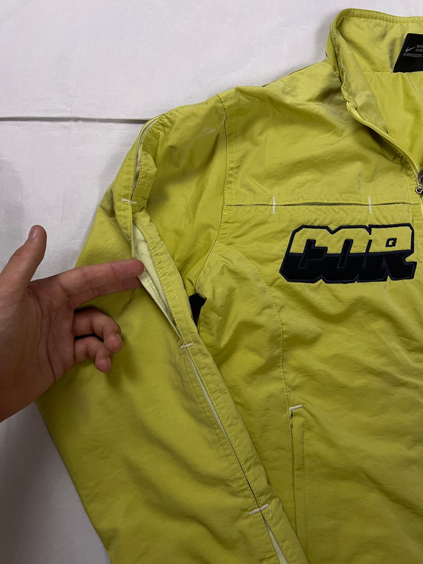 Nike yellow track jacket lightweight nylon with bold embroidered logos and sleeve zipper vent.
