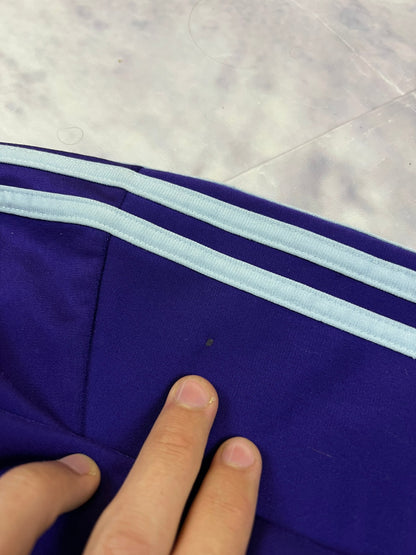 Adidas men's purple track jacket with embroidered logo and white stripes on sleeves.