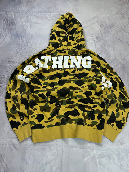 A Bathing Ape black hoodie yellow and green camo pattern with white ape head logo.