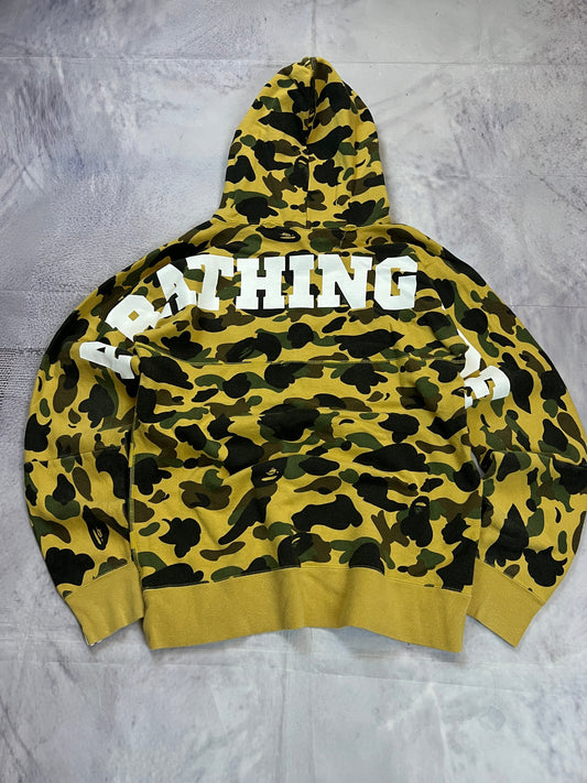 A Bathing Ape black hoodie yellow and green camo pattern with white ape head logo.