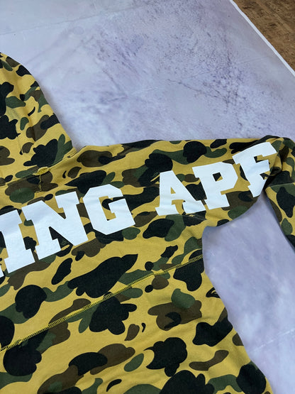 A Bathing Ape black hoodie yellow and green camo pattern with white ape head logo.