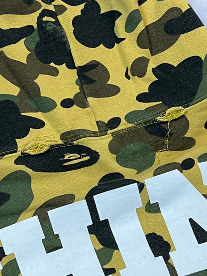 A Bathing Ape black hoodie yellow and green camo pattern with white ape head logo.