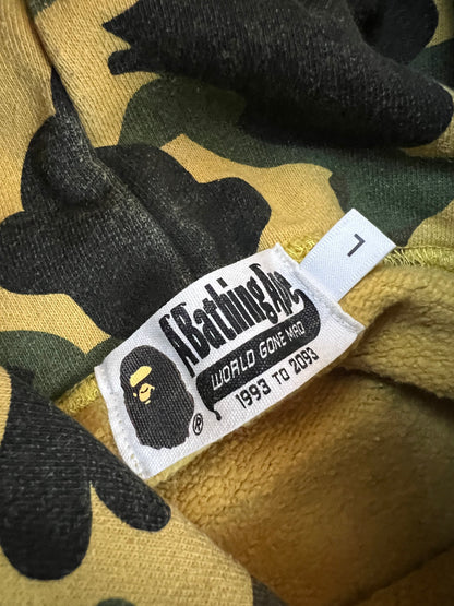 A Bathing Ape black hoodie yellow and green camo pattern with white ape head logo.