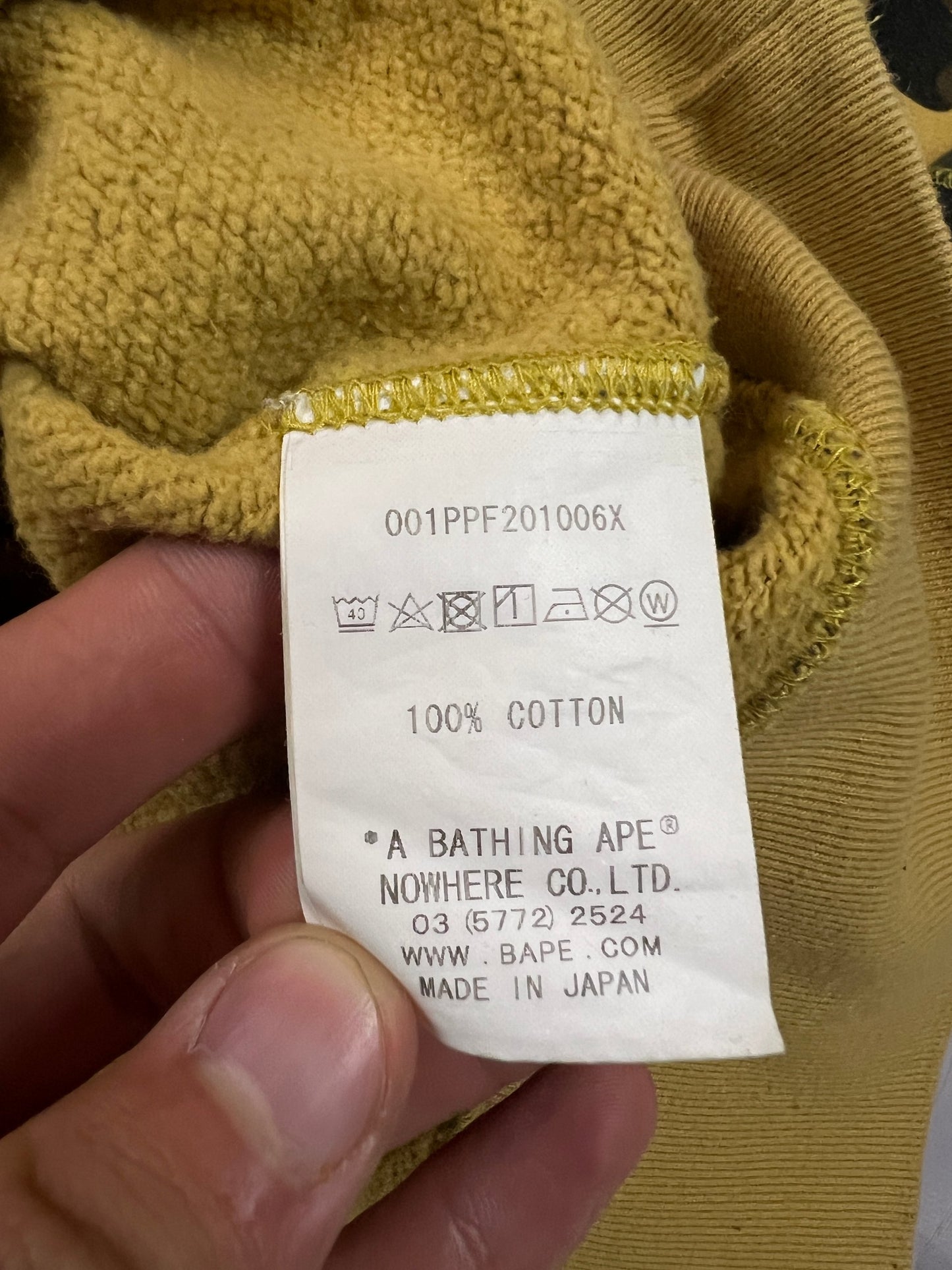 A Bathing Ape black hoodie yellow and green camo pattern with white ape head logo.