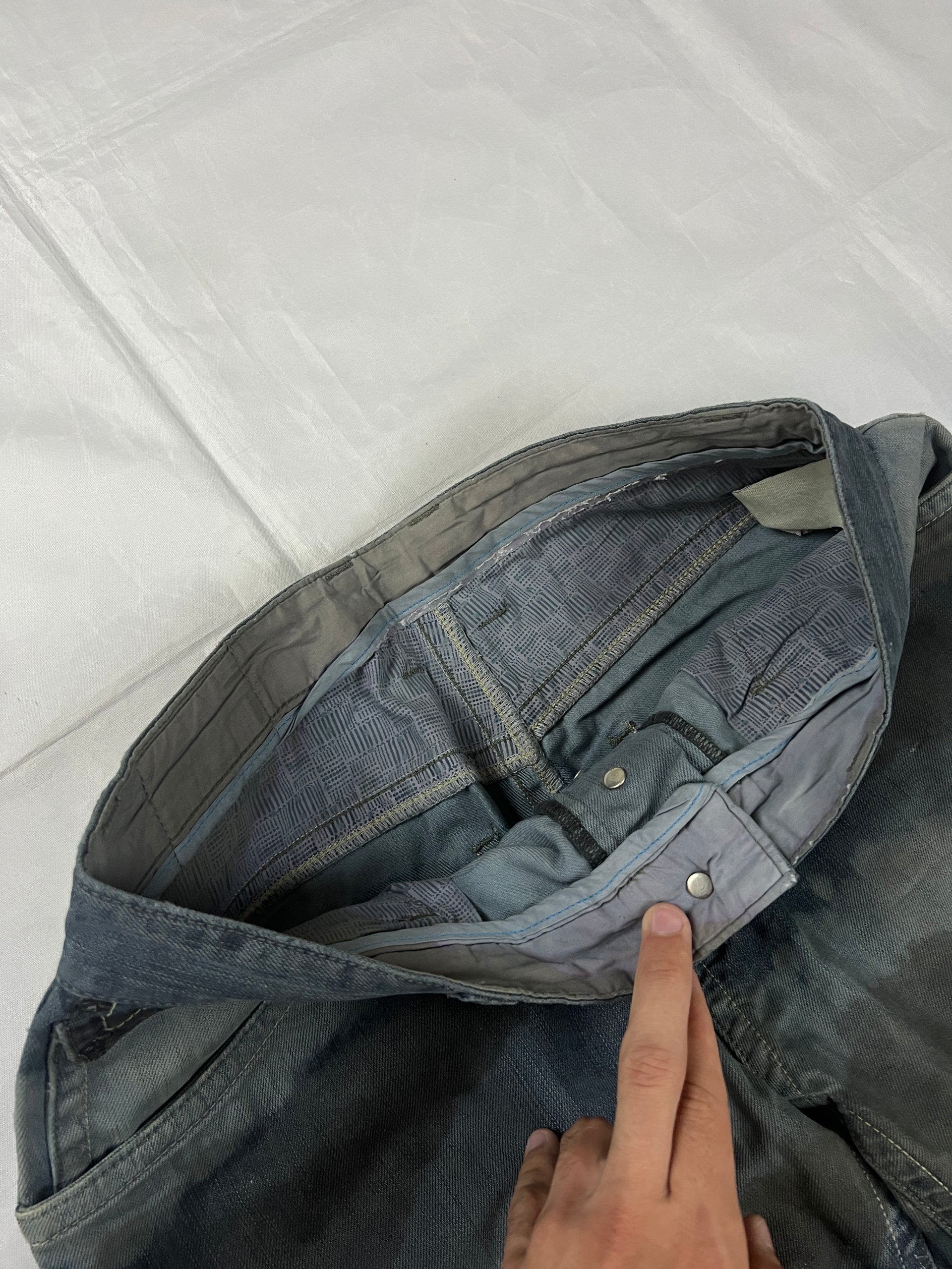 Lee blue and grey striped denim jeans with loose fit and decorative stitching.