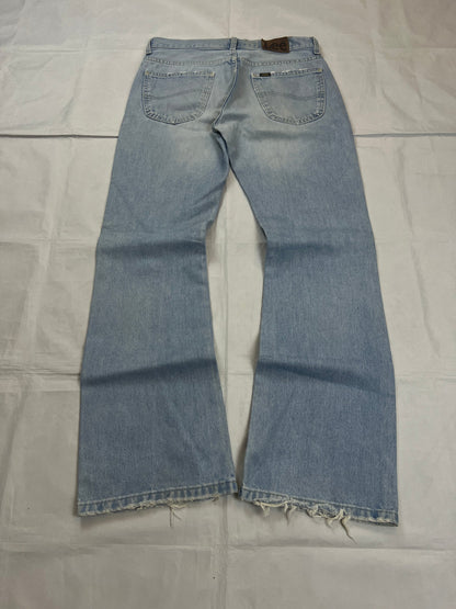 Lee light blue flared jeans with leather patch, five-pocket styling, and frayed hems.