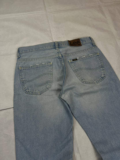 Lee light blue flared jeans with leather patch, five-pocket styling, and frayed hems.