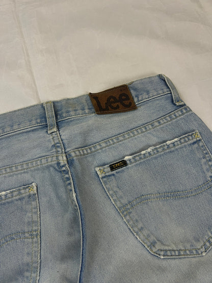 Lee light blue flared jeans with leather patch, five-pocket styling, and frayed hems.