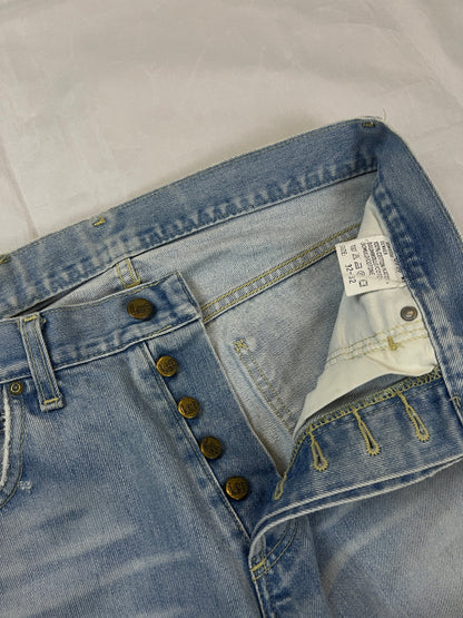 Lee light blue flared jeans with leather patch, five-pocket styling, and frayed hems.