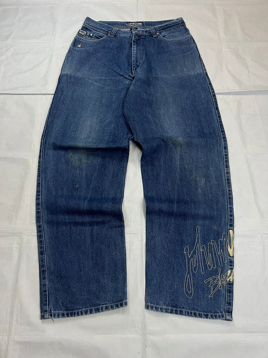 Johnny Blaze blue wide leg jeans with embroidered logo and leather patch on waistband.