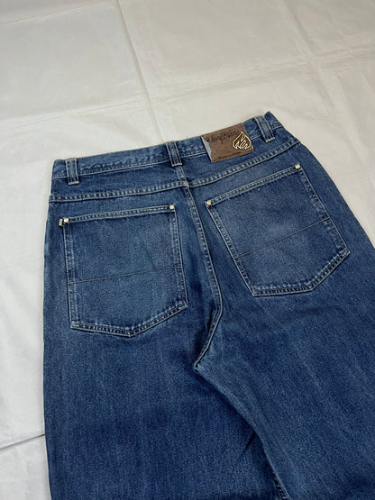 Johnny Blaze blue wide leg jeans with embroidered logo and leather patch on waistband.