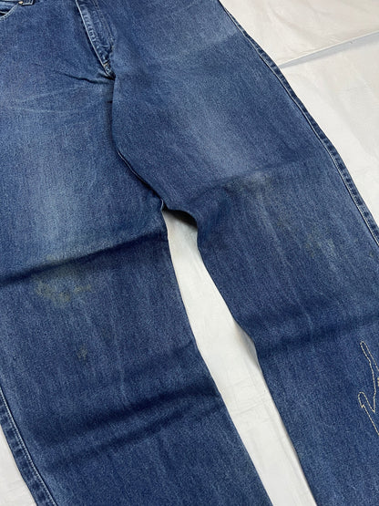 Johnny Blaze blue wide leg jeans with embroidered logo and leather patch on waistband.