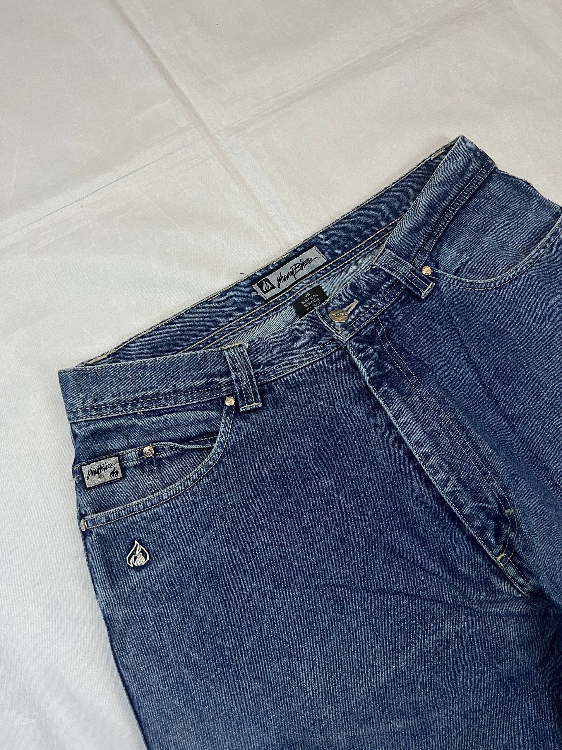 Johnny Blaze blue wide leg jeans with embroidered logo and leather patch on waistband.