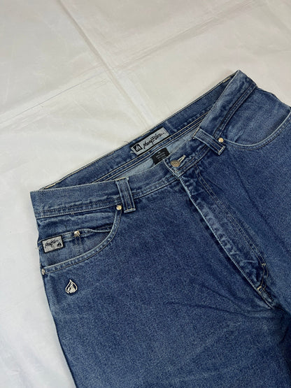 Johnny Blaze blue wide leg jeans with embroidered logo and leather patch on waistband.