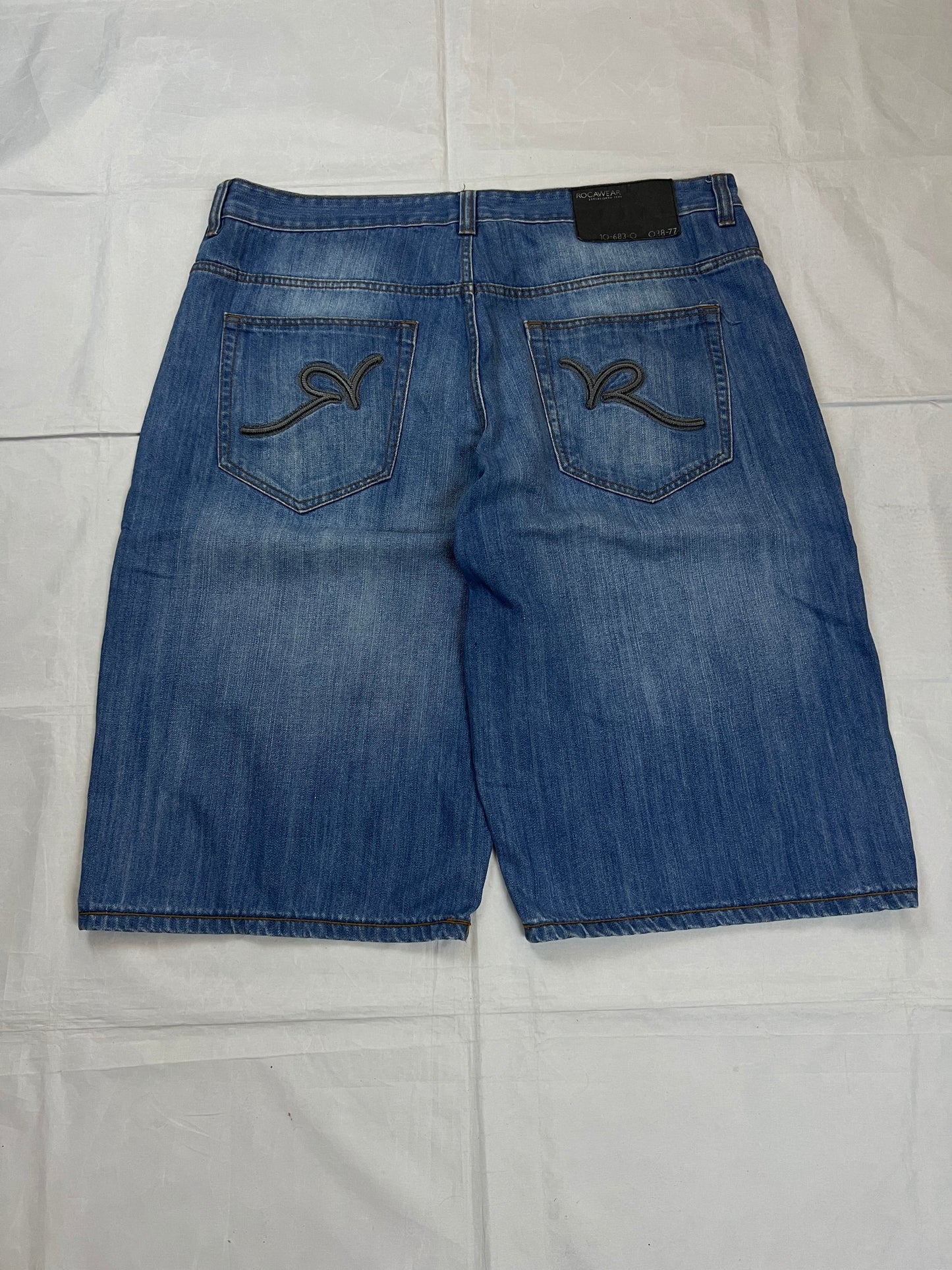 Rocawear blue denim shorts W38 five-pocket design with embroidered back pockets and branded label.