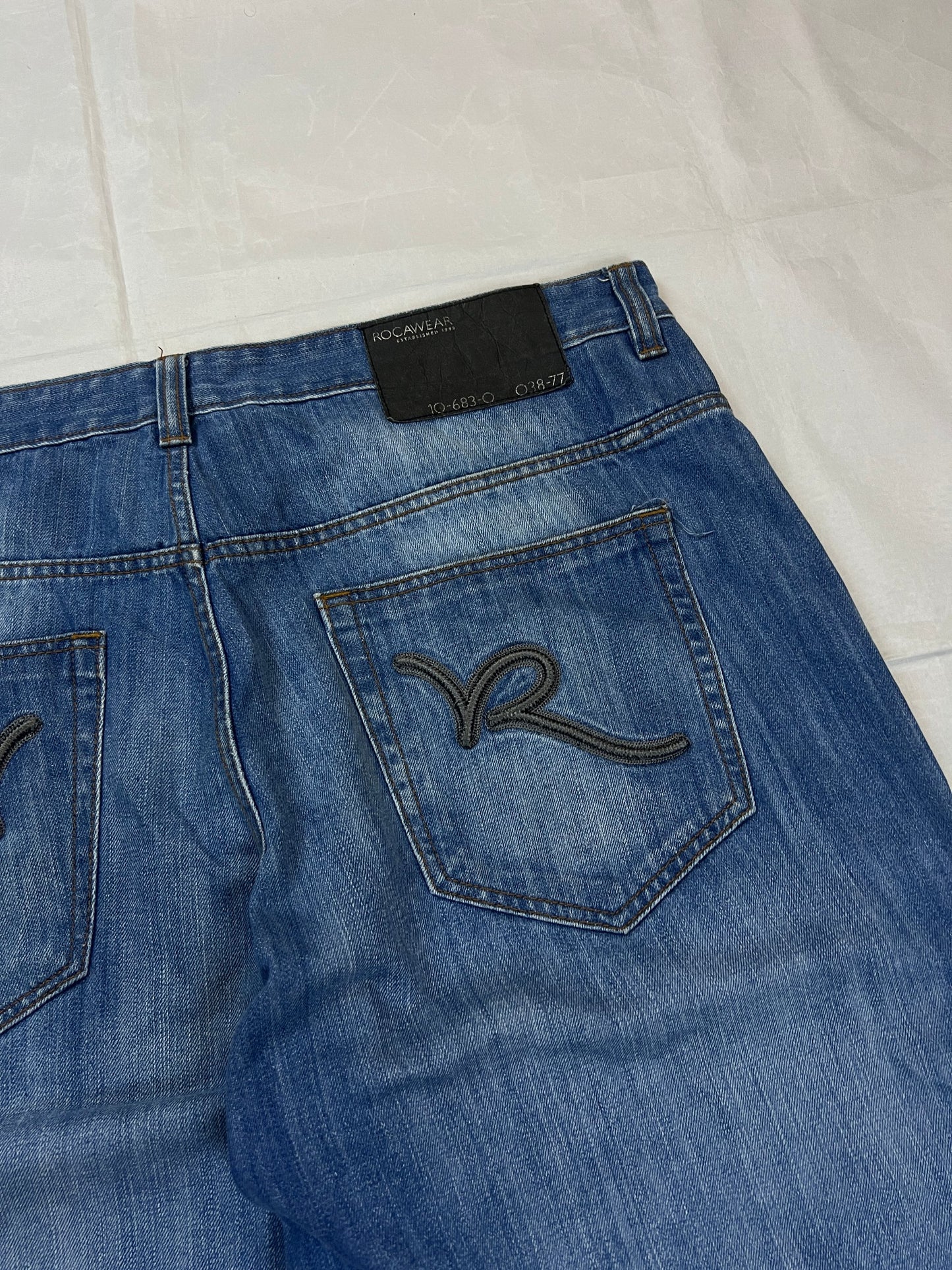 Rocawear blue denim shorts W38 five-pocket design with embroidered back pockets and branded label.
