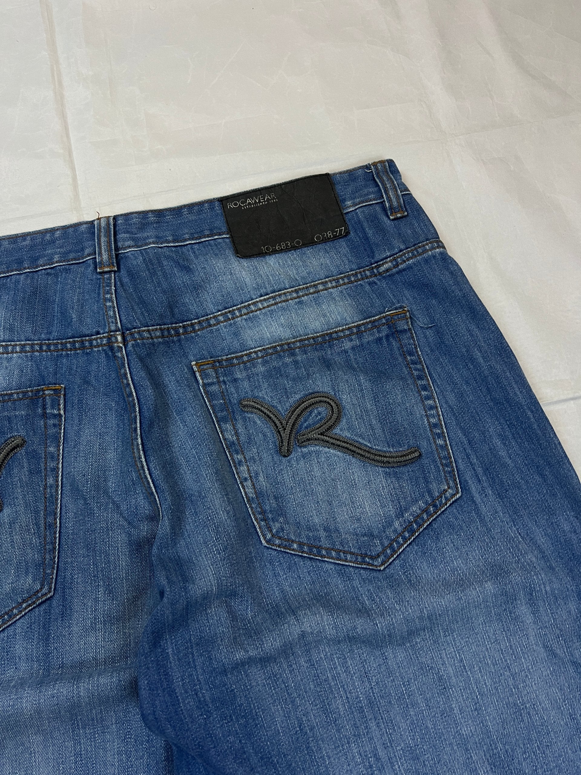 Rocawear blue denim shorts W38 five-pocket design with embroidered back pockets and branded label.