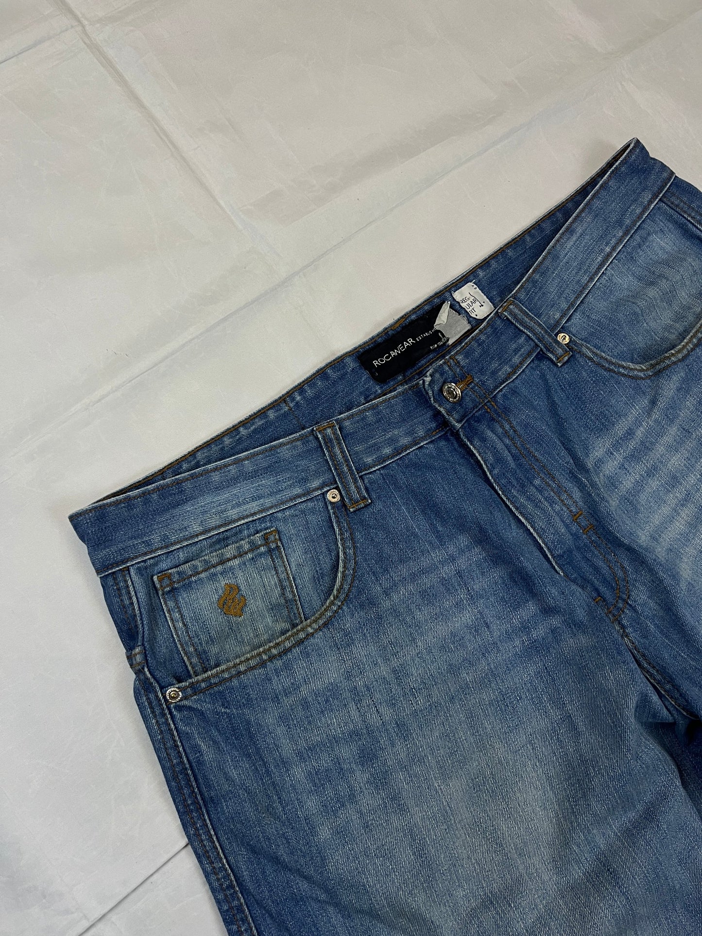 Rocawear blue denim shorts W38 five-pocket design with embroidered back pockets and branded label.