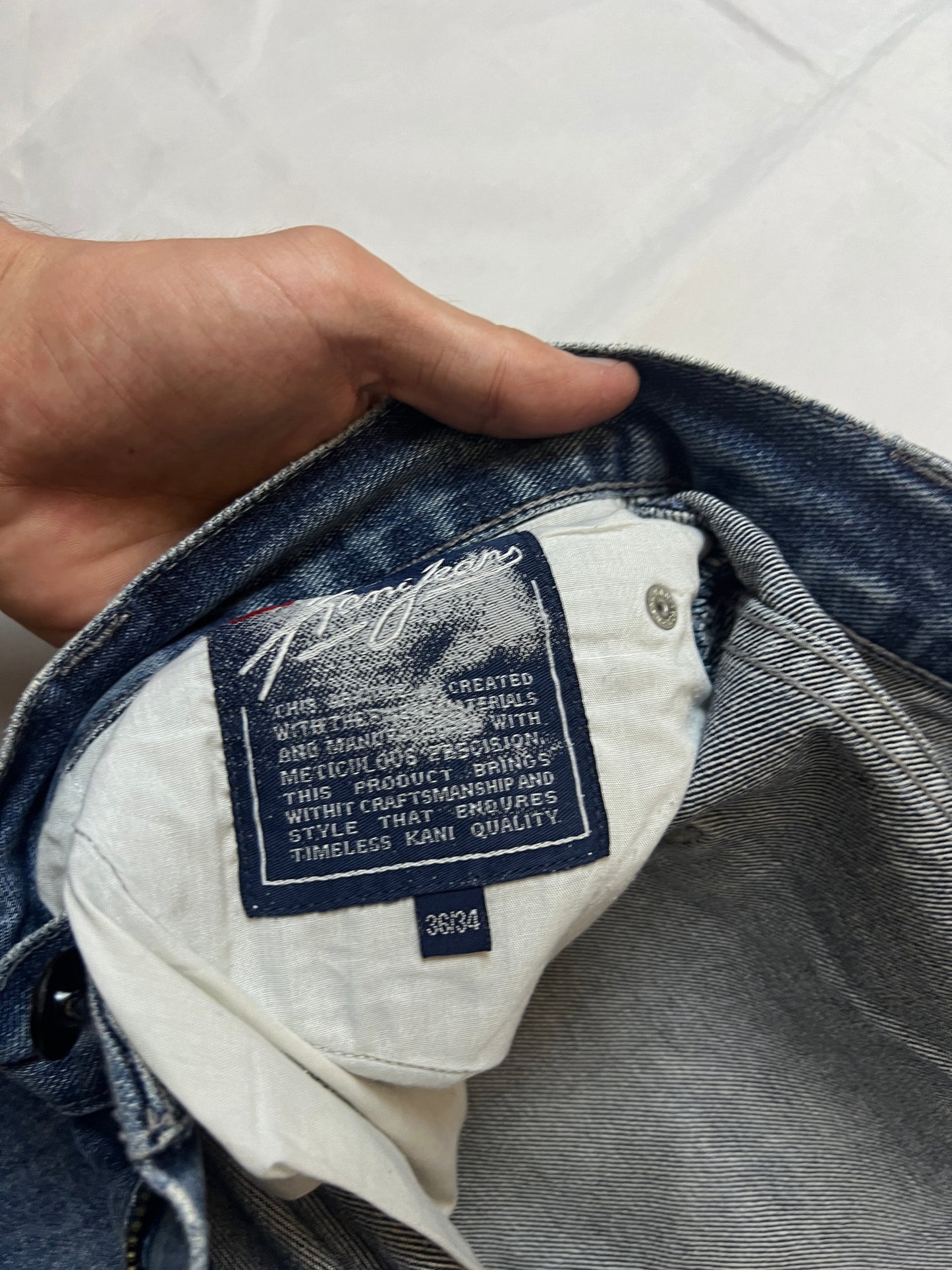 Kani blue denim carpenter jeans with distressed details, faded wash, and patch pockets.