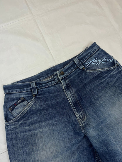 Kani blue denim carpenter jeans with distressed details, faded wash, and patch pockets.