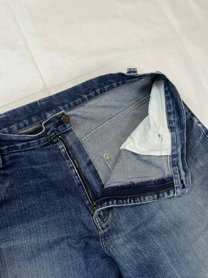 Kani blue denim carpenter jeans with distressed details, faded wash, and patch pockets.