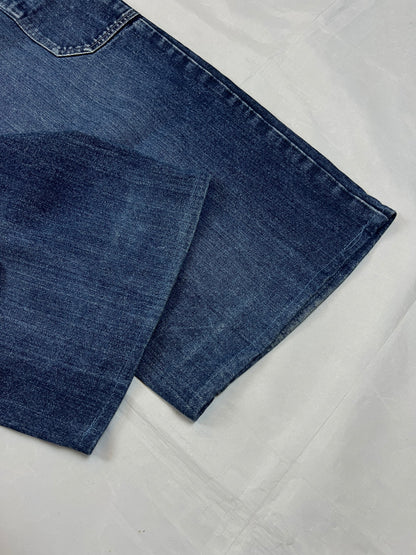 Kani blue denim carpenter jeans with distressed details, faded wash, and patch pockets.