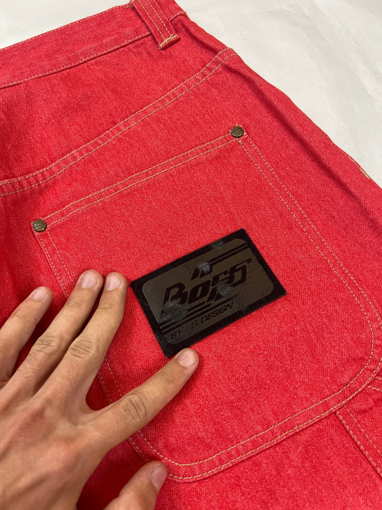 BOSS red carpenter jeans 100% cotton with yellow stitching and logo detailing.