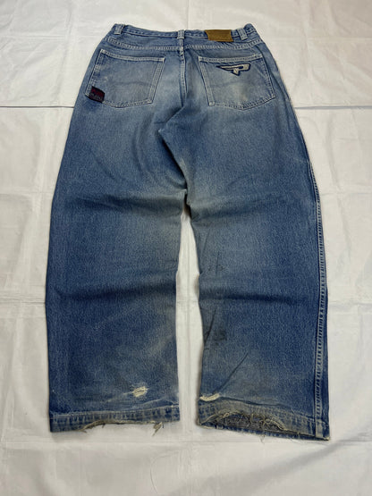 Pure Playaz blue denim jeans with distressed rips, faded wash, and branded patches.