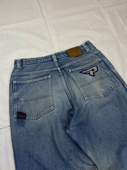 Pure Playaz blue denim jeans with distressed rips, faded wash, and branded patches.