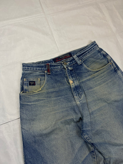 Pure Playaz blue denim jeans with distressed rips, faded wash, and branded patches.