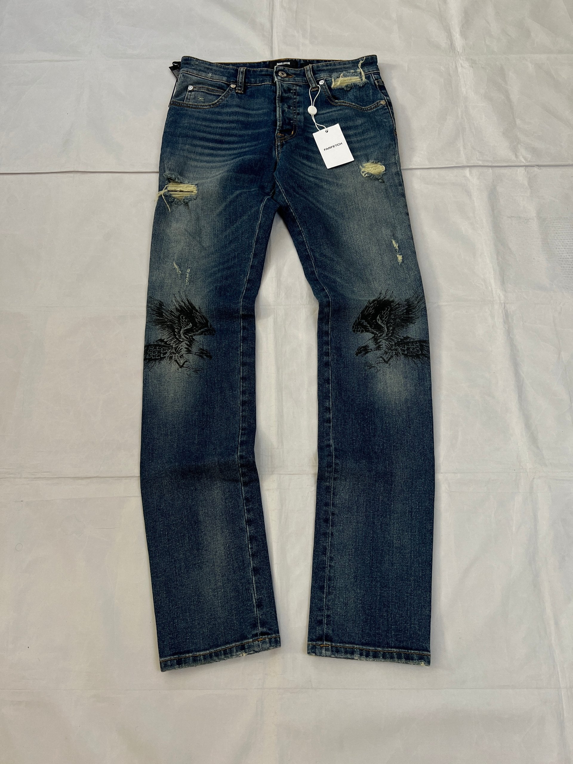 Just Cavalli blue distressed denim jeans UK 10 with black eagle prints on knees.