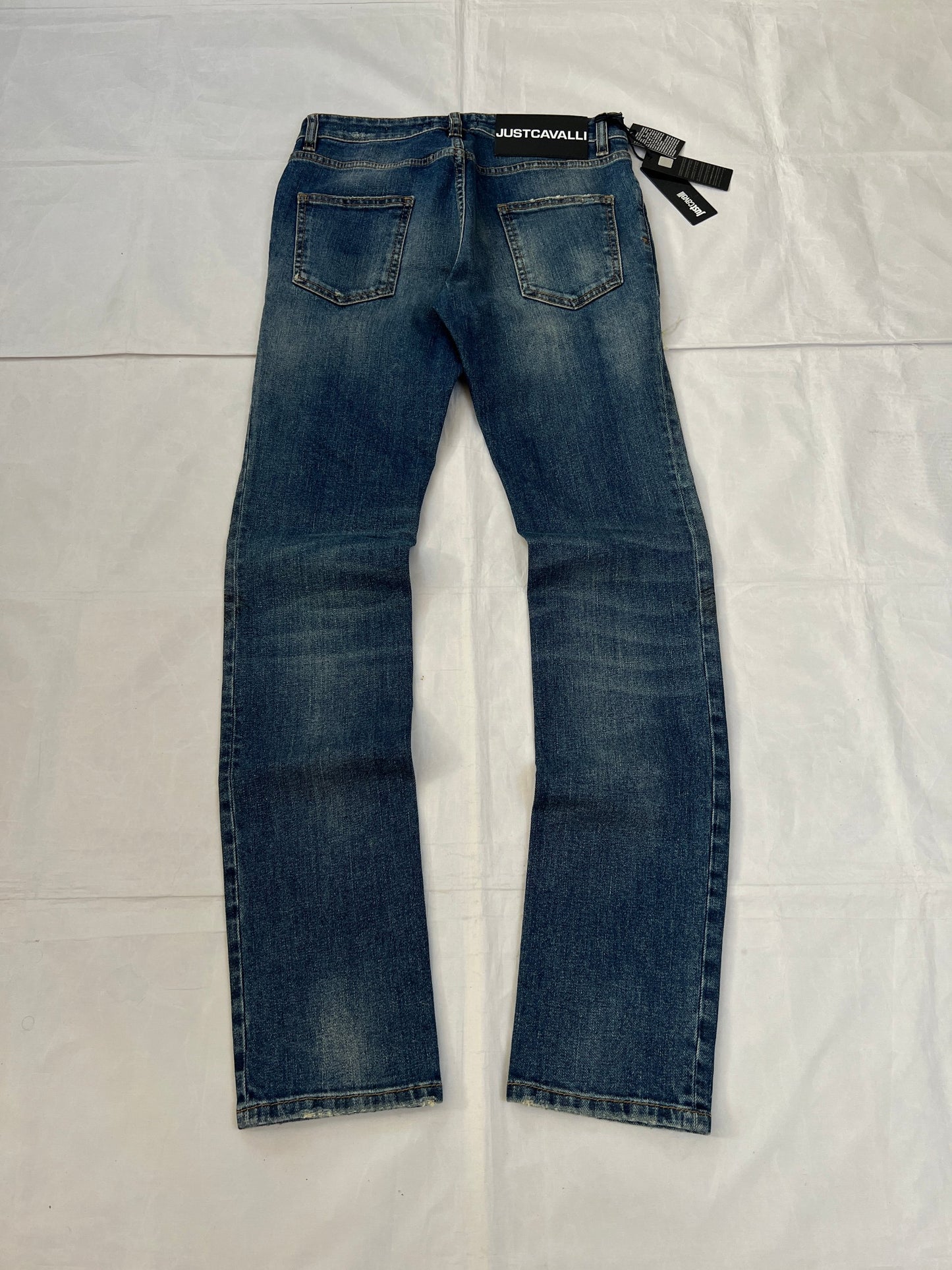 Just Cavalli blue distressed denim jeans UK 10 with black eagle prints on knees.