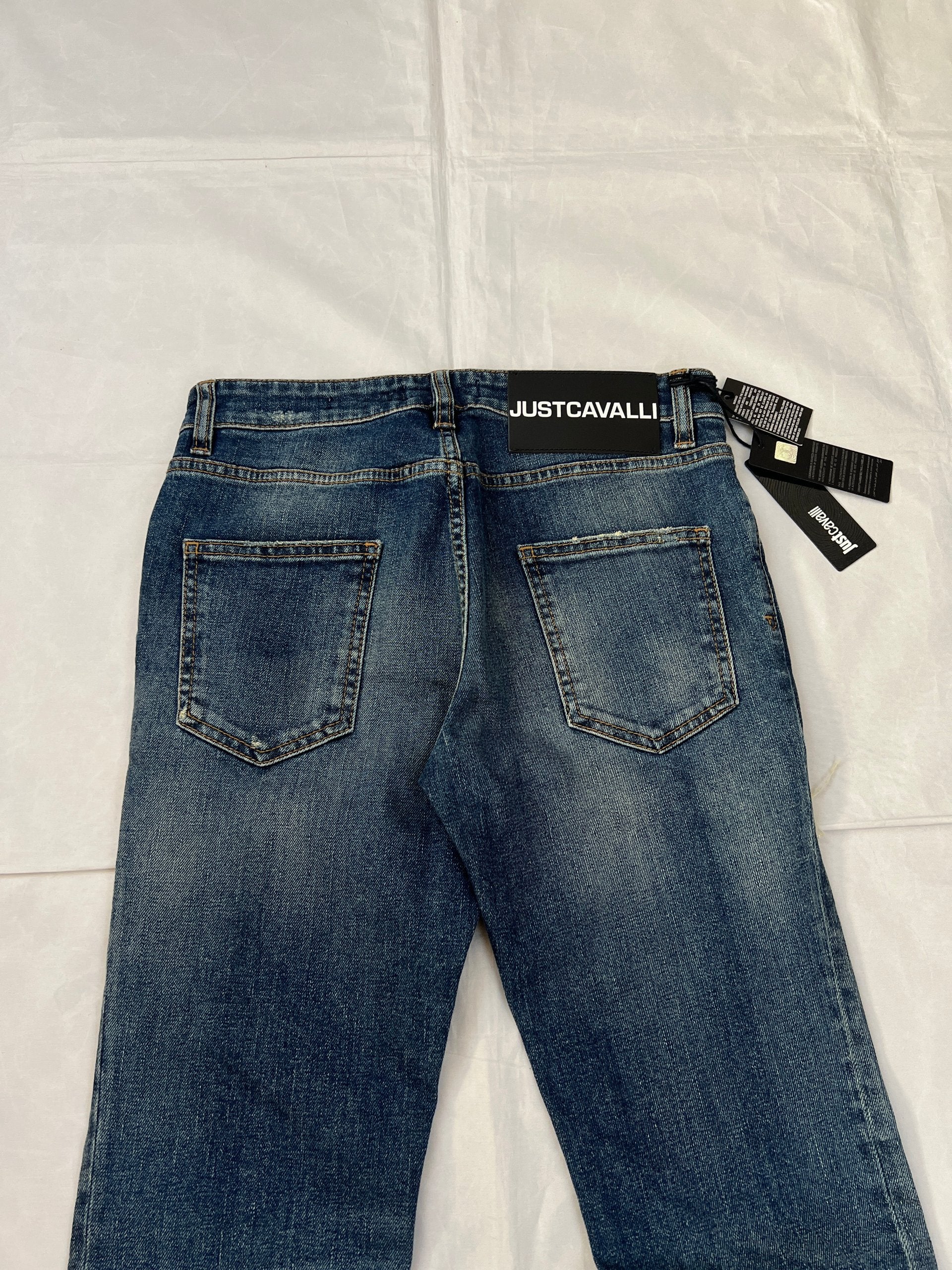 Just Cavalli blue distressed denim jeans UK 10 with black eagle prints on knees.