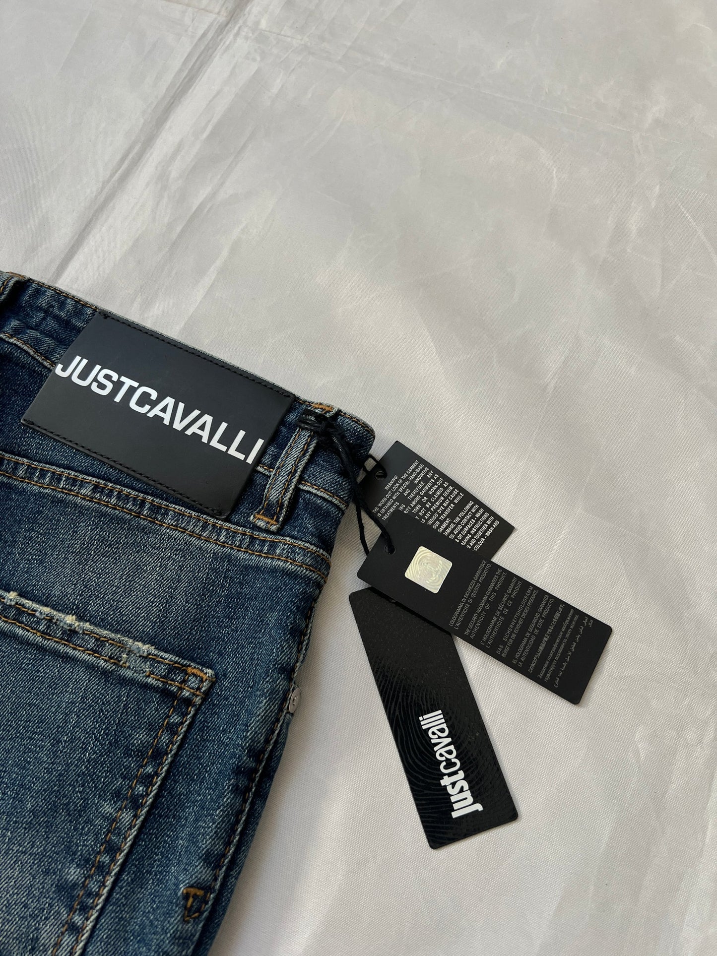 Just Cavalli blue distressed denim jeans UK 10 with black eagle prints on knees.
