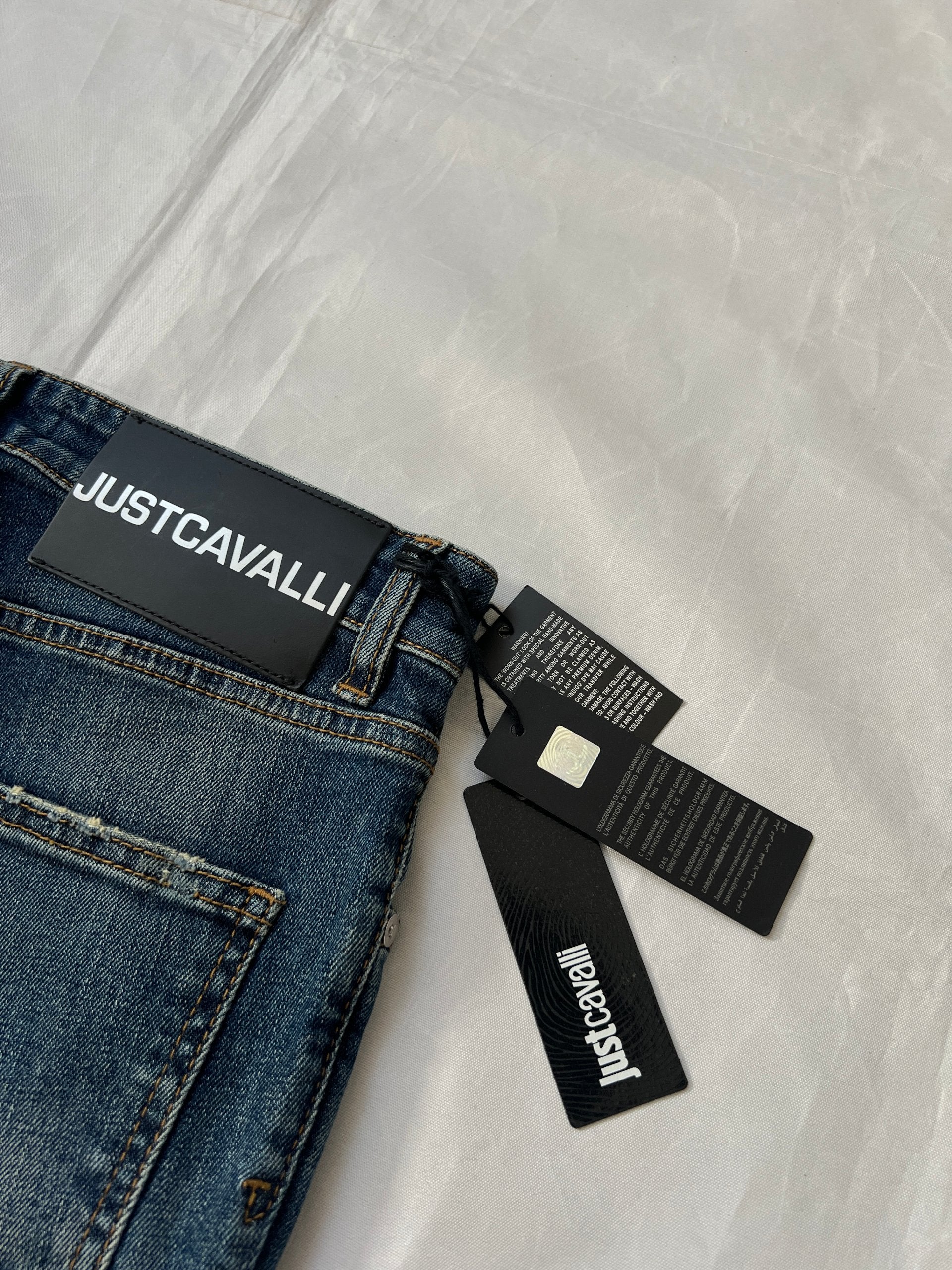 Just Cavalli blue distressed denim jeans UK 10 with black eagle prints on knees.