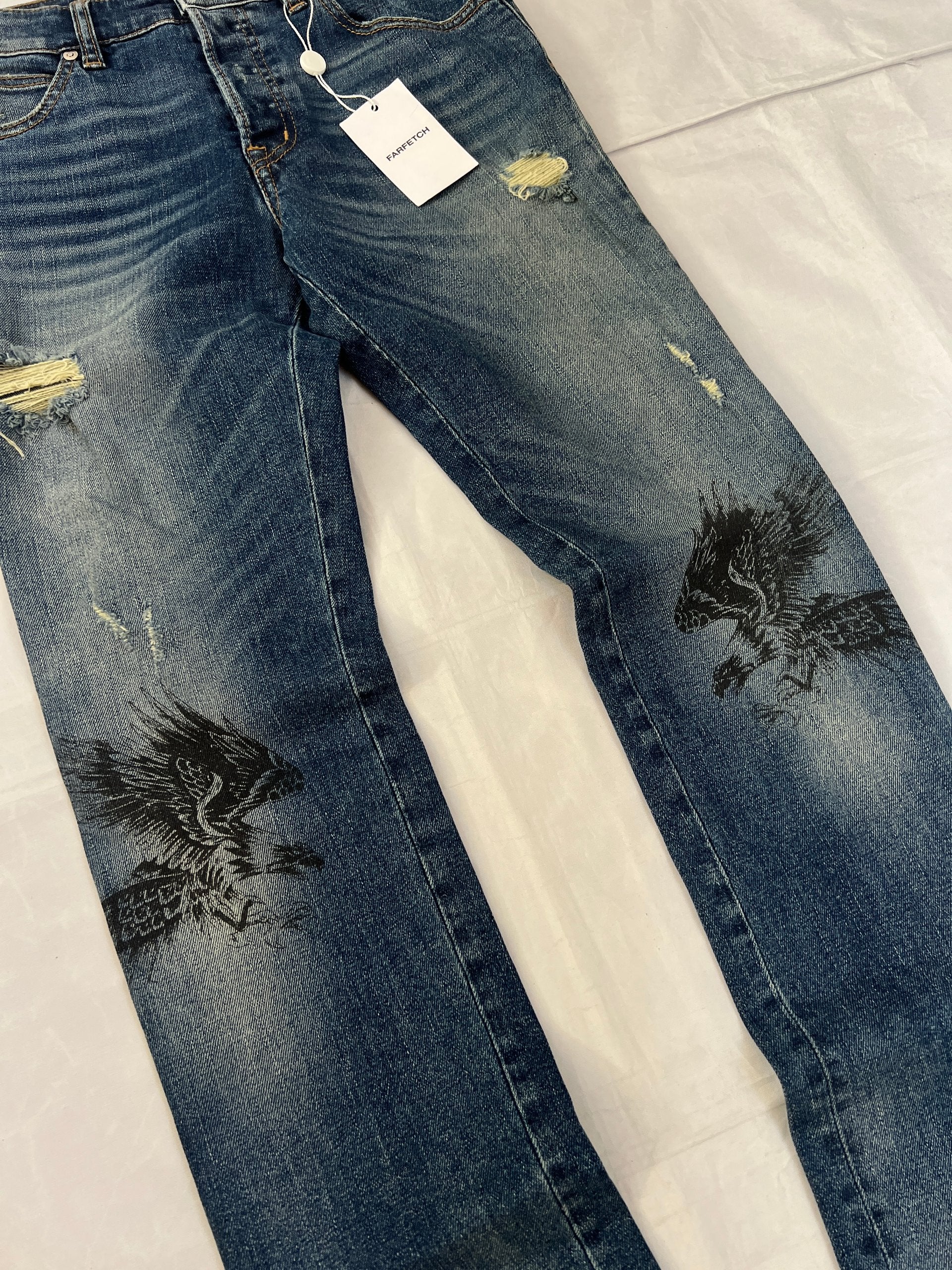 Just Cavalli blue distressed denim jeans UK 10 with black eagle prints on knees.