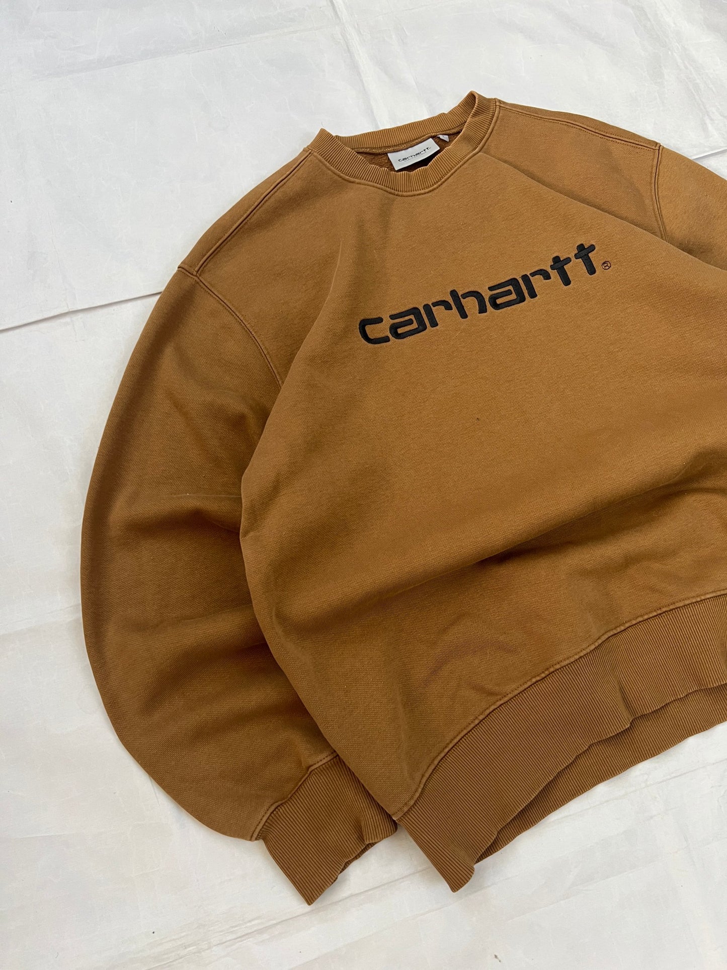 Carhartt brown hooded sweatshirt with black logo, fleece lined cotton-poly blend.