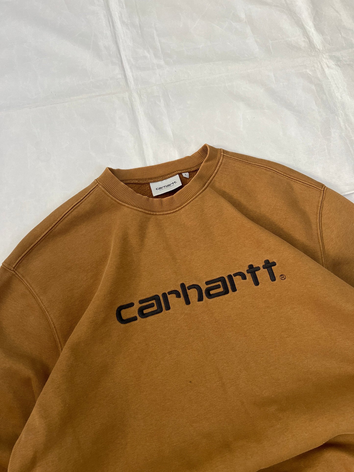 Carhartt brown hooded sweatshirt with black logo, fleece lined cotton-poly blend.