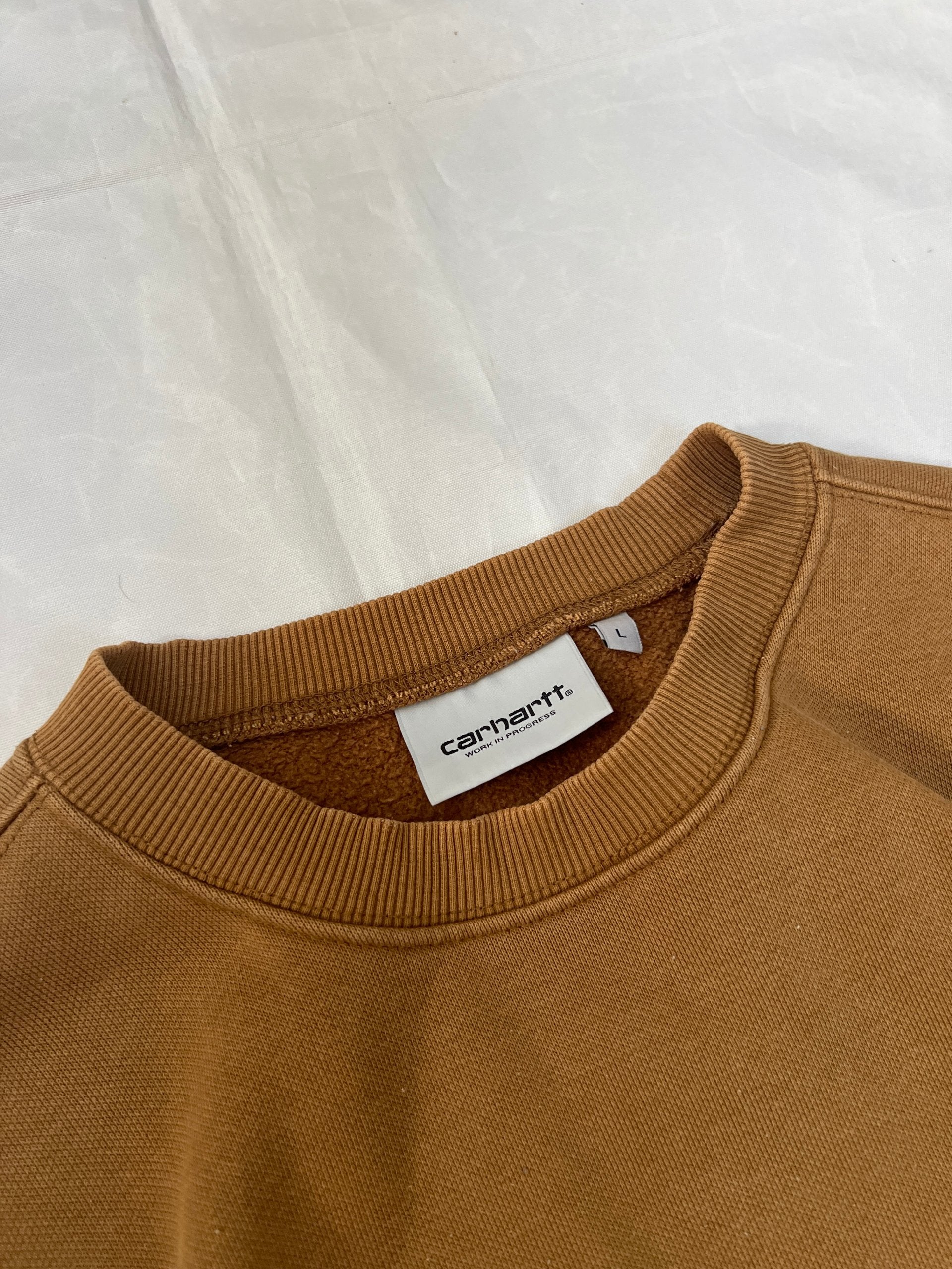Carhartt brown hooded sweatshirt with black logo, fleece lined cotton-poly blend.