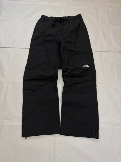 The North Face black hiking trousers with embroidered logo and adjustable Velcro ankle closures.