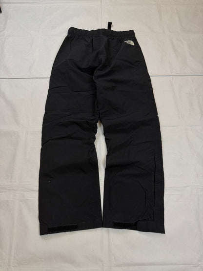 The North Face black hiking trousers with embroidered logo and adjustable Velcro ankle closures.