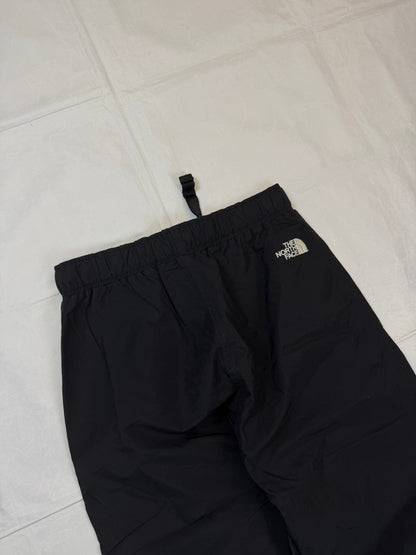 The North Face black hiking trousers with embroidered logo and adjustable Velcro ankle closures.