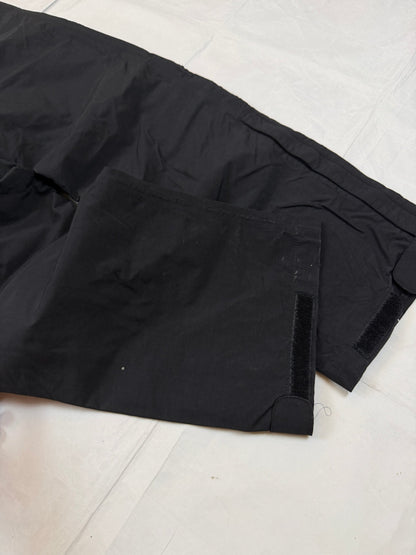 The North Face black hiking trousers with embroidered logo and adjustable Velcro ankle closures.