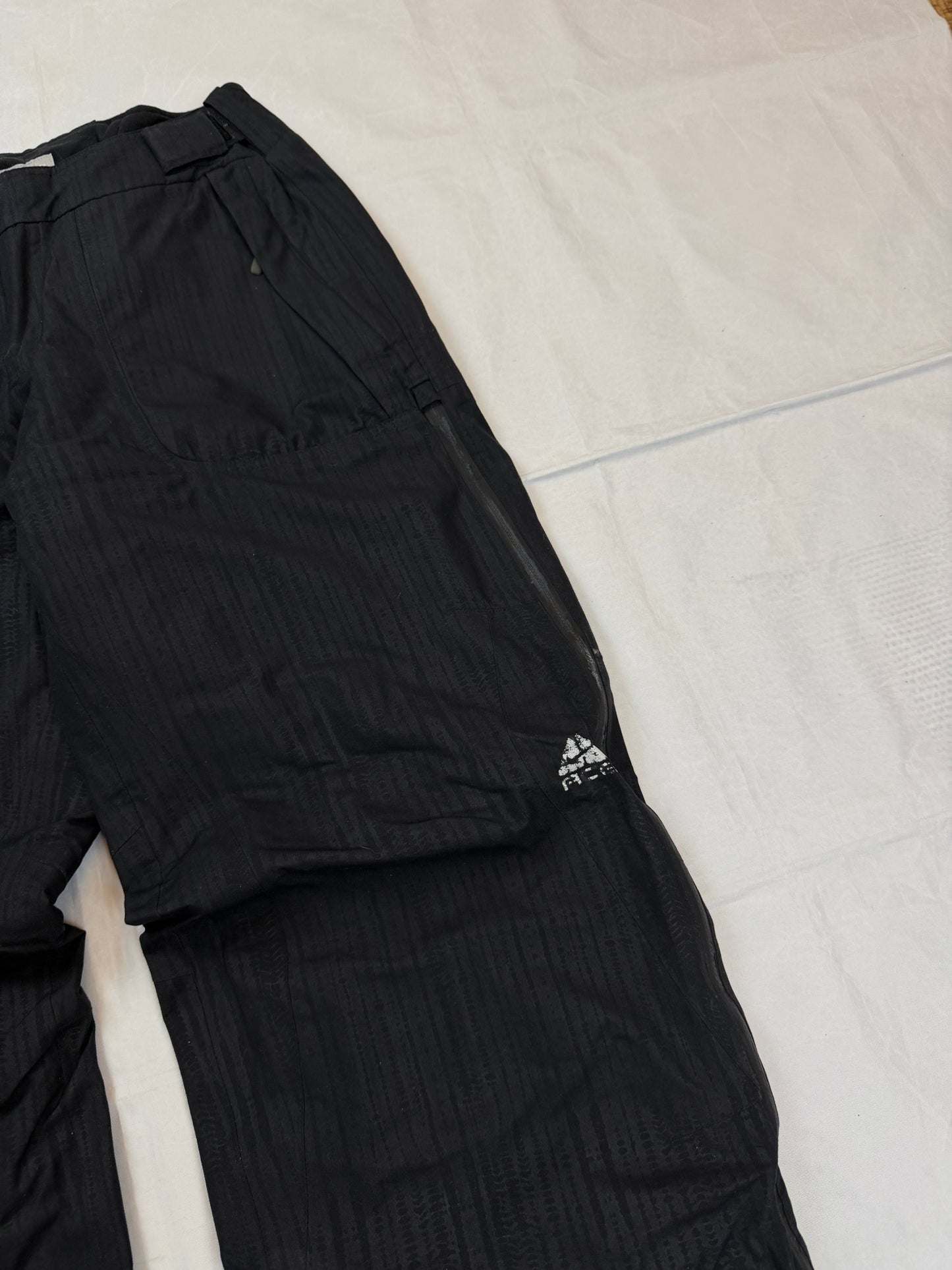 Nike black snow pants with ACG and Gore-Tex logos, adjustable waist, zippered vents.