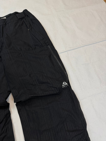 Nike black snow pants with ACG and Gore-Tex logos, adjustable waist, zippered vents.